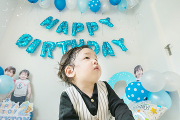 Closeup happy asian in room with birthday decoration in 2 nd years anniversary concept