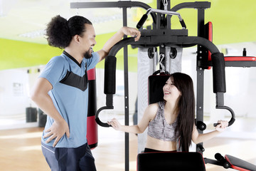 Asian woman and afro man laugh together