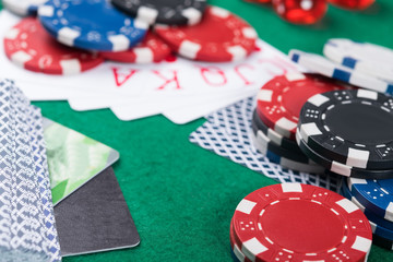 winning combinations of cards on a green poker table, bank cards to pay for victory