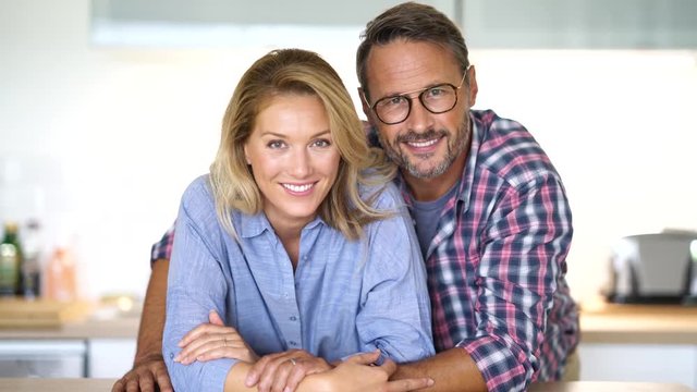 Portrait of mature couple standing in home kitchen