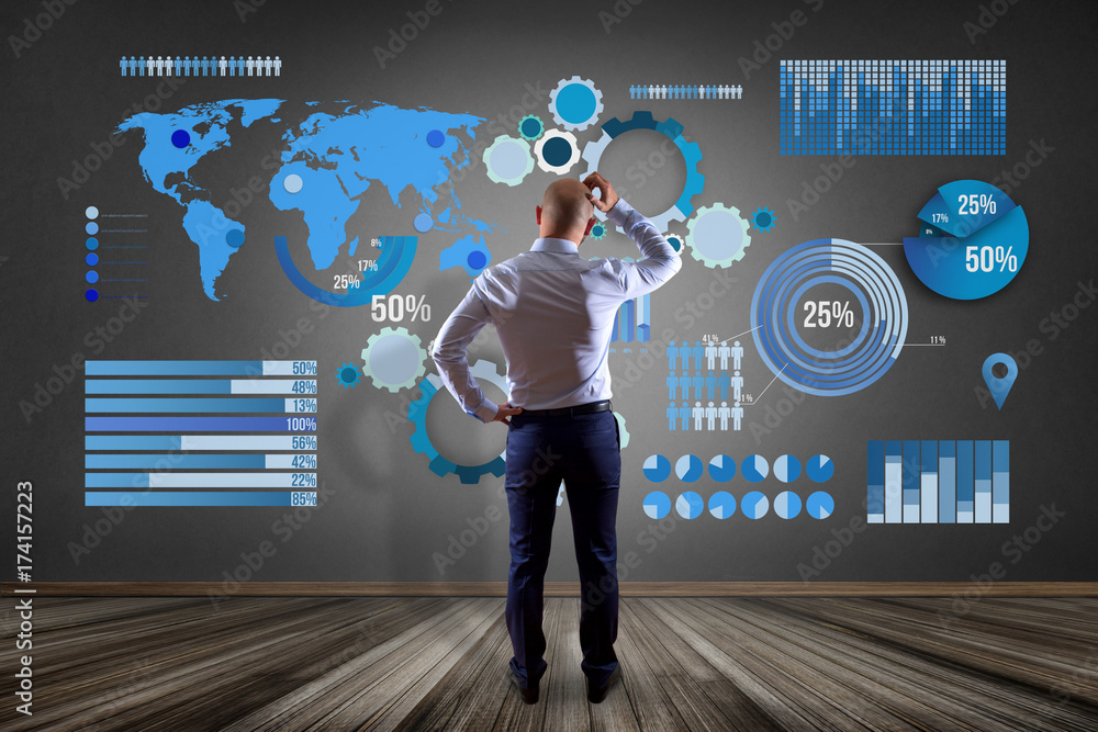Poster businessman in front of a wall thinking about a business graph and chart interface - business concep
