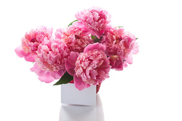 bouquet of pink peonies in a wicker vase