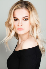 Blonde Woman with Makeup and Permed Hairstyle