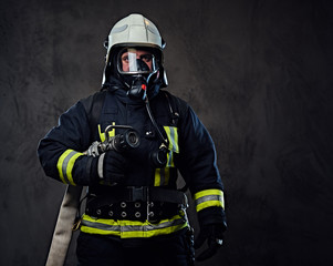Fototapeta premium Firefighter dressed in uniform and an oxygen mask.
