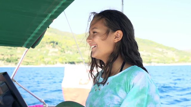 Teenage girl sailing, piloting boat on sea, super slow motion 120fps
