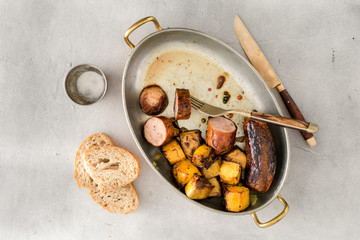 Top view fried sausages with pumpkin in frying pan