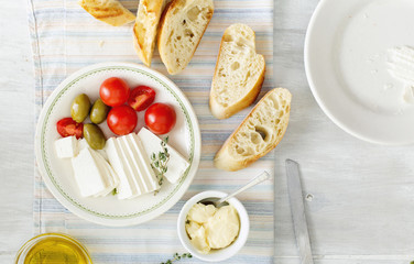 Ingredients for cooking Italian bruschetta on white wooden table