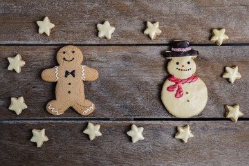 Festive Christmas Cookie and New Year in the shape of Gingerbread man, snowman, Snowflake, star on wooden table