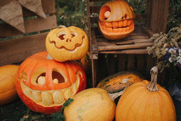Ghost pumpkins on Halloween. Рead Jack on an autumn background. Holiday outdoor decorations