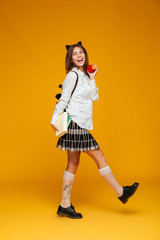 Full length portrait of a happy schoolgirl in uniform