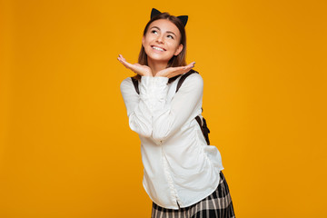 Portrait of a lovely smiling schoolgirl with backpack