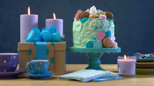4k Happy Fathers Day or masculine birthday party table with showstopper cake decorated with candy, marshmallows and macarons cookies, static.