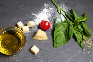 Spices for pizza, olive oil, salt, garlic, tomatoes, parmesan cheese, pepper, bay leaves