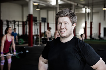Fototapeta na wymiar Confident Man Smiling In Fitness Center
