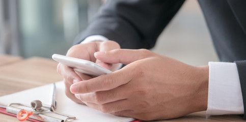 The soft and selective focused image of businessman using smartphone.