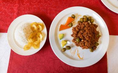 Typical Cuban minced meat recipe.served with fried banana slices and rice