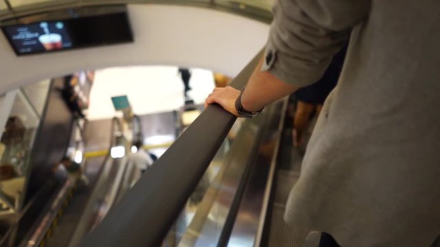 Young man on escalator at the shopping mall