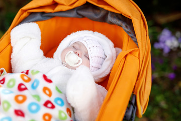 Portrait of adorable newborn baby in warm winter clothes