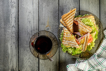 Panini sandwich with ham, tomato and lettuce.