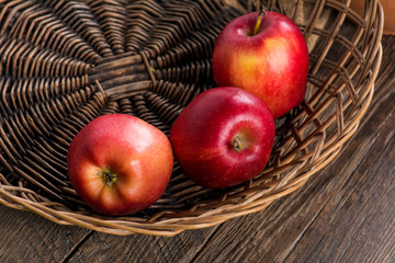 Fresh apples in wicker basket