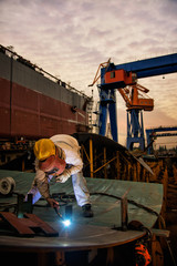 A welder at a shipyard