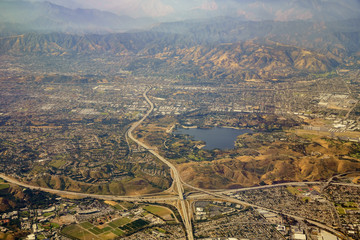 Aerial view of San Dimas and Puddingstone Reservoir, view from window seat in an airplane