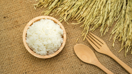 Jasmine rice in a bowl on a wooden table.