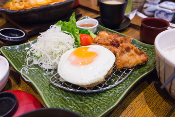 Fried chicken nuggets and fried egg.