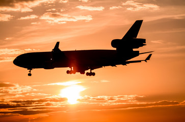Airplane landing at sunset