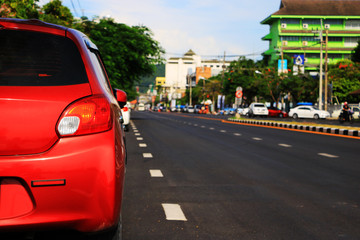  red  car parking lot on daytime