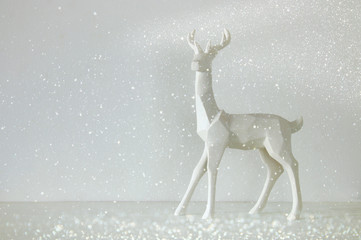 White reindeer on wooden table over white background