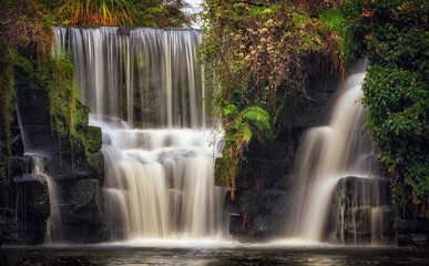 Waterfall at Penllergare Valley Woods on the Afon Llan river, easily accessible just off junction 47 of the M4 motorway in Swansea, UK.