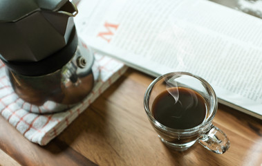 Hot Coffee in Espresso Cup with Magazine on the Table