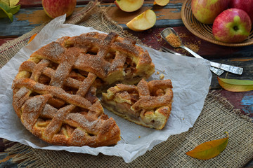 Homemade organic apple pie from yeast dough on wooden background. Fruit dessert ready to eat