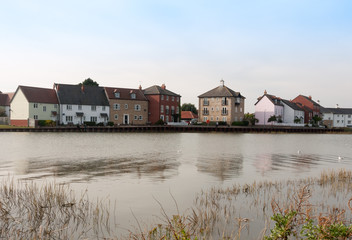 row of houses coast marina dock other side of river
