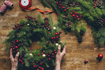 hands holding Christmas wreath