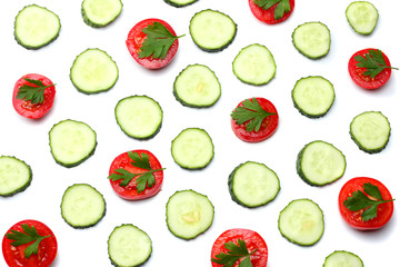 mix of sliced cucumber with sliced tomato isolated on a white background top view