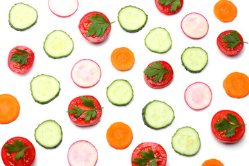 mix of sliced cucumber with sliced carrot and tomato isolated on a white background top view