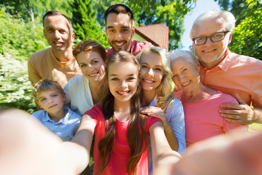 happy family taking selfie in summer garden