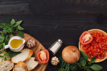 Preparing delicious Italian tomato bruschetta with chopped vegetables, herbs and oil