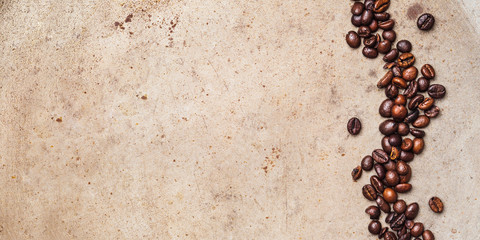 Whole Coffee beans on textured rusty background. Flat lay