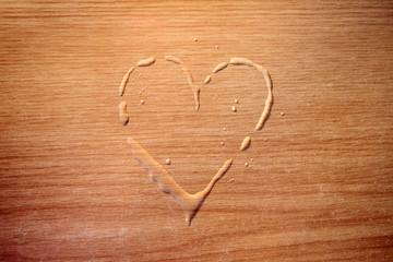 water heart on wood, love concept on wooden surface