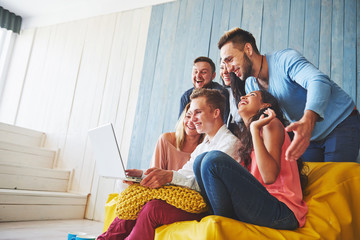 Naklejka premium Group of creative young Friends Hanging Social Media Concept. People Together Discussing Creative Project During Work Process, play games or watch video film