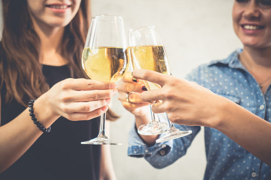 Group of women celebrating in a party, clinking glasses of wine,beer,liquor, spirit, booze with happy and relaxing feeling, party and celebration concept vintage tone