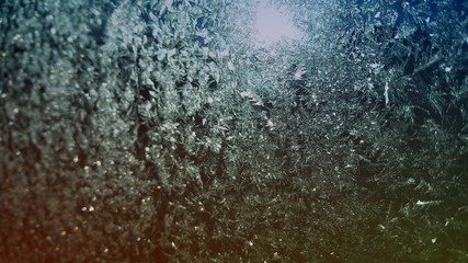Rays of sunlight shining on a car's frozen window