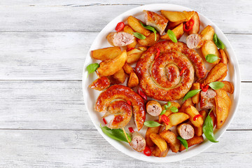 hot fried sausages and potato on platter