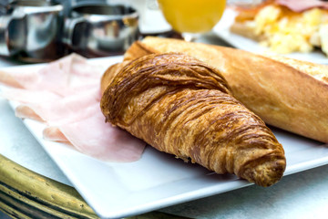 Breakfast with coffee and croissants on table