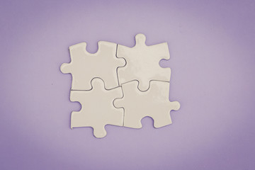 CONNECTED BLANK PUZZLE PIECES ON BACKGROUND CONCEPT