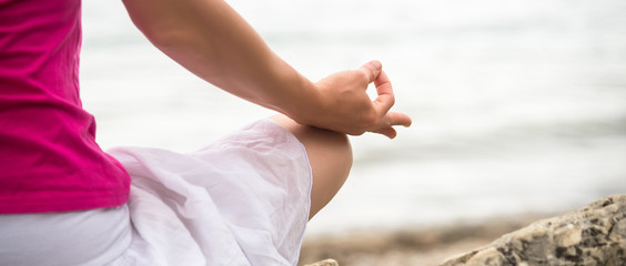 Woman meditating at the lake