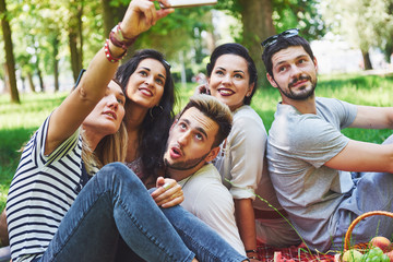 Happy friends having fun outside in nature